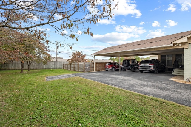 view of parking with a yard