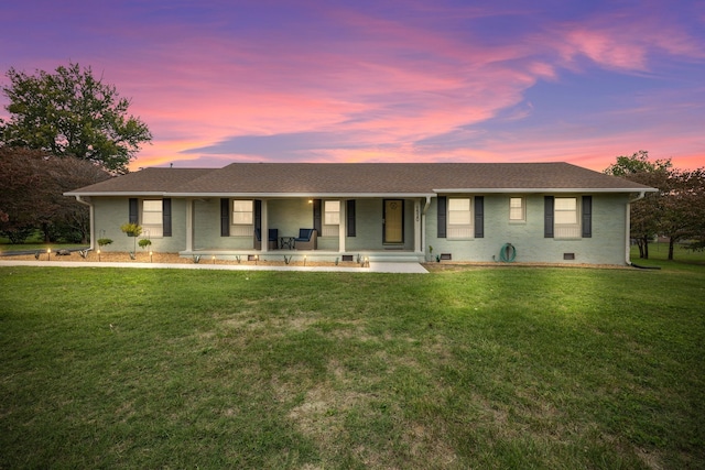 ranch-style home with a lawn