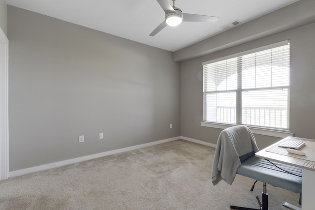 office space featuring ceiling fan and light colored carpet