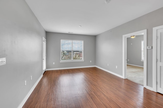 empty room with hardwood / wood-style flooring