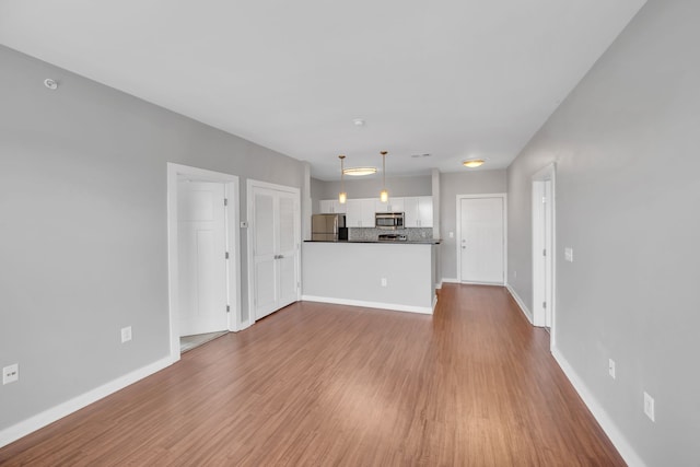 unfurnished living room featuring hardwood / wood-style floors