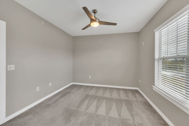 unfurnished room featuring ceiling fan and light colored carpet