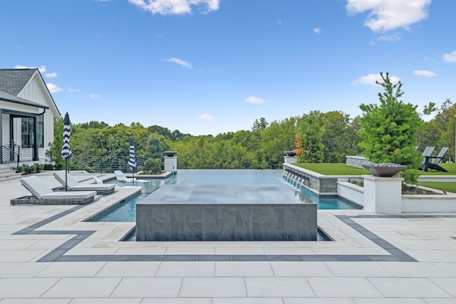 view of pool featuring pool water feature, a patio area, and a jacuzzi