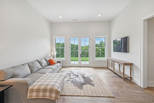 living room featuring french doors and light hardwood / wood-style floors