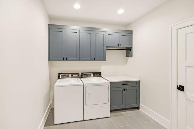 laundry area featuring cabinets and washing machine and dryer