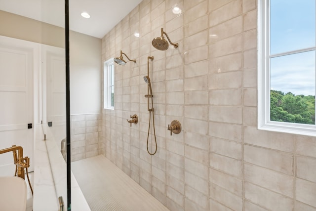 bathroom with a wealth of natural light and tiled shower