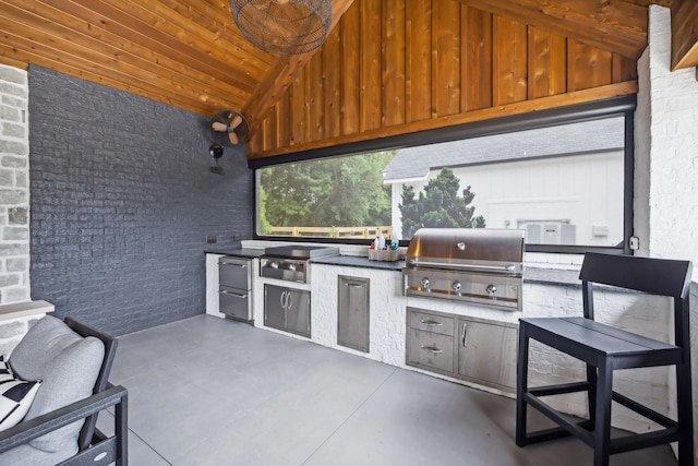 view of patio with an outdoor kitchen and area for grilling