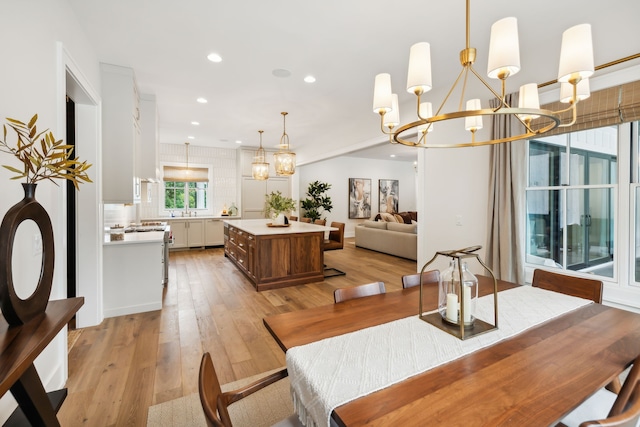 dining area featuring a notable chandelier and light wood-type flooring