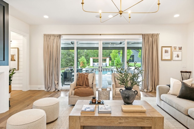 living room featuring light hardwood / wood-style flooring and an inviting chandelier