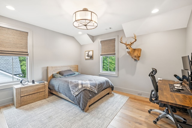 bedroom featuring light hardwood / wood-style flooring and multiple windows