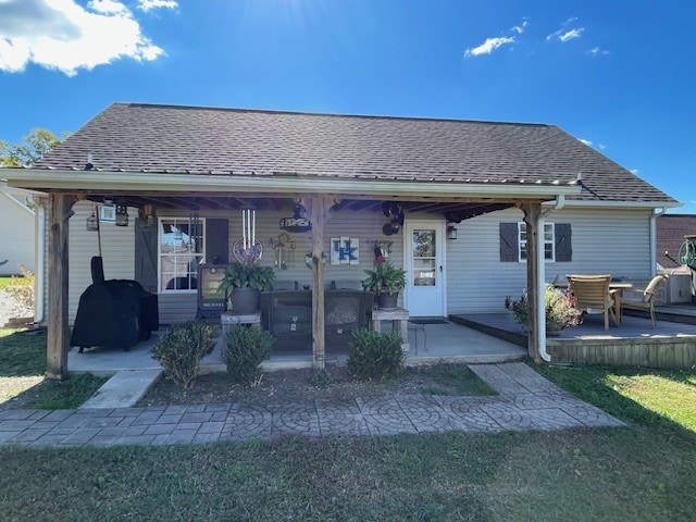 back of property with a patio and a lawn