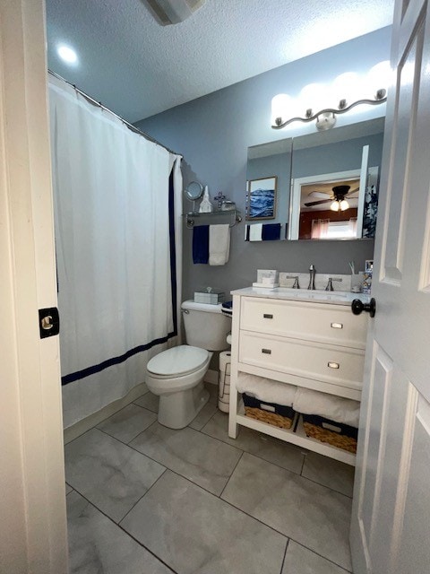 bathroom with tile patterned floors, toilet, a textured ceiling, vanity, and ceiling fan