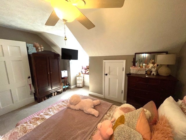 bedroom with ceiling fan, vaulted ceiling, and light colored carpet