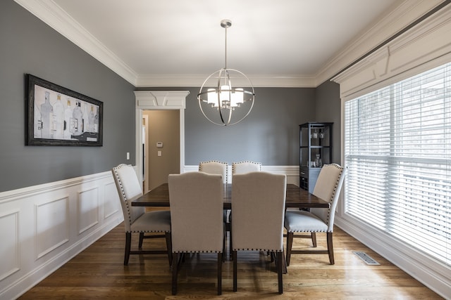 dining area featuring a healthy amount of sunlight, visible vents, a notable chandelier, and wood finished floors