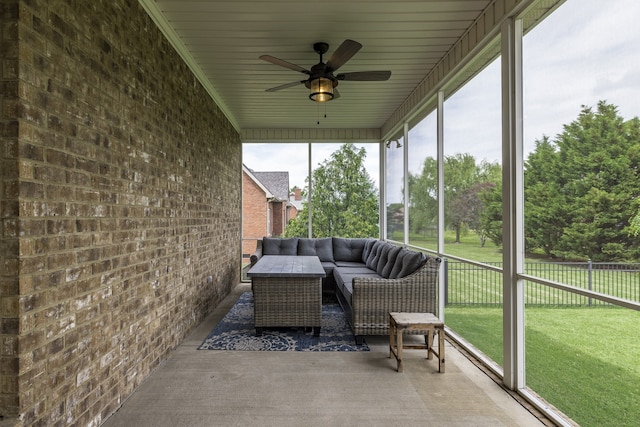 sunroom featuring ceiling fan