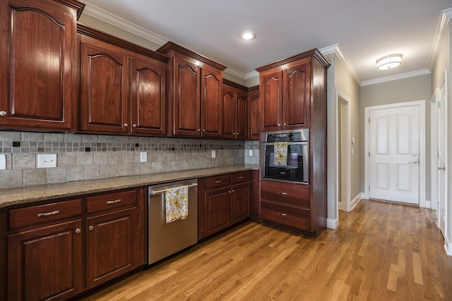 kitchen featuring light stone counters, crown molding, light wood finished floors, decorative backsplash, and appliances with stainless steel finishes