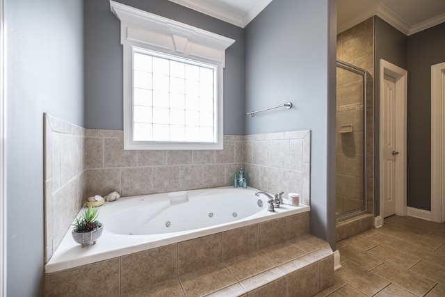 bathroom with a stall shower, crown molding, and a jetted tub