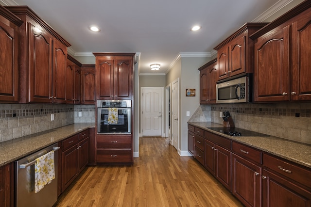 kitchen with stainless steel appliances, baseboards, ornamental molding, light wood-type flooring, and tasteful backsplash