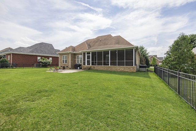 back of property featuring a yard, a fenced backyard, and a patio