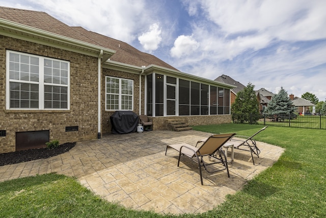 view of patio / terrace featuring area for grilling, fence, and a sunroom