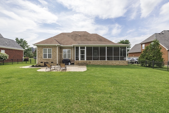 rear view of house featuring a fenced backyard, a sunroom, a lawn, crawl space, and a patio area