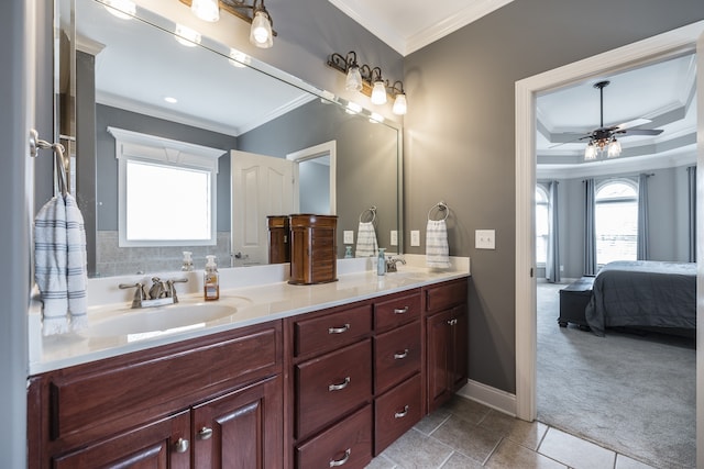 ensuite bathroom featuring ornamental molding, double vanity, a sink, and a ceiling fan