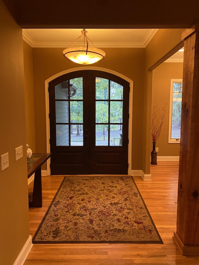 2271 Timberwood Trce, Monteagle, TN 37356 - foyer entrance with light wood-style floors, arched walkways, french doors, baseboards, and ornamental molding