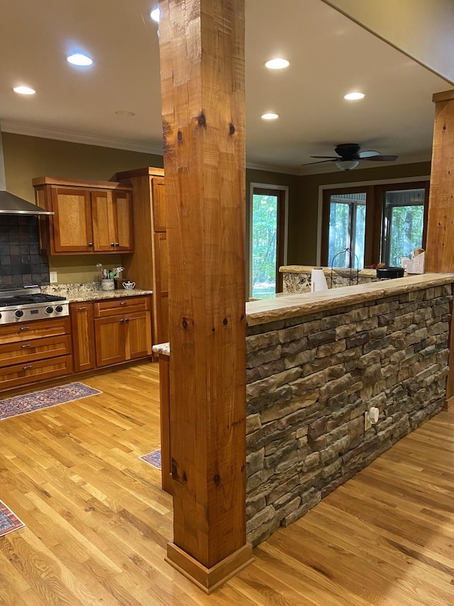 2271 Timberwood Trce, Monteagle, TN 37356 - kitchen featuring stainless steel gas cooktop, a healthy amount of sunlight, light wood-style floors, brown cabinets, and crown molding