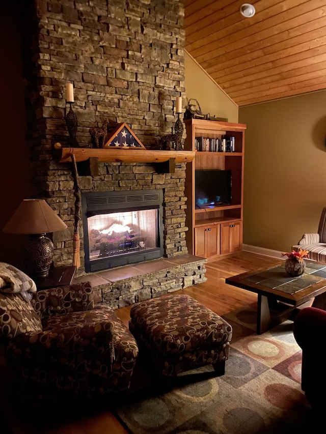 2271 Timberwood Trce, Monteagle, TN 37356 - living area with lofted ceiling, wooden ceiling, wood finished floors, and a stone fireplace
