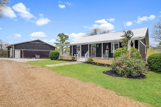 single story home with a front yard and an outdoor structure