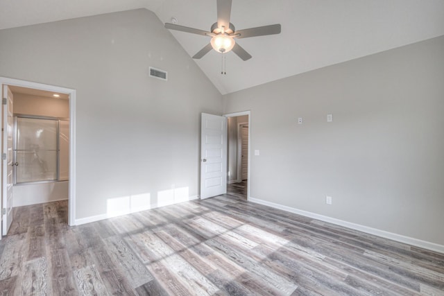 unfurnished bedroom featuring ensuite bath, high vaulted ceiling, ceiling fan, and light wood-type flooring