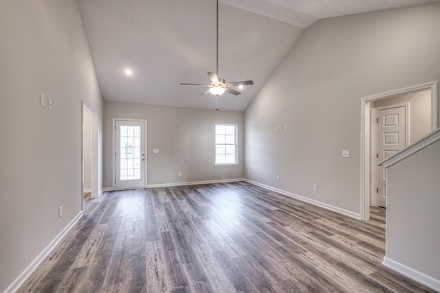 unfurnished living room with ceiling fan, dark hardwood / wood-style flooring, and high vaulted ceiling