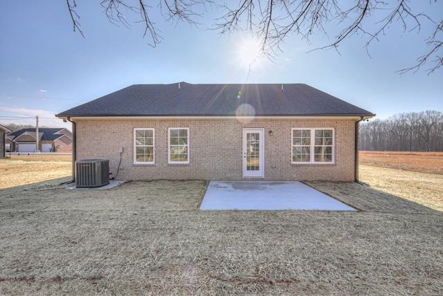 back of property with a yard and a patio area