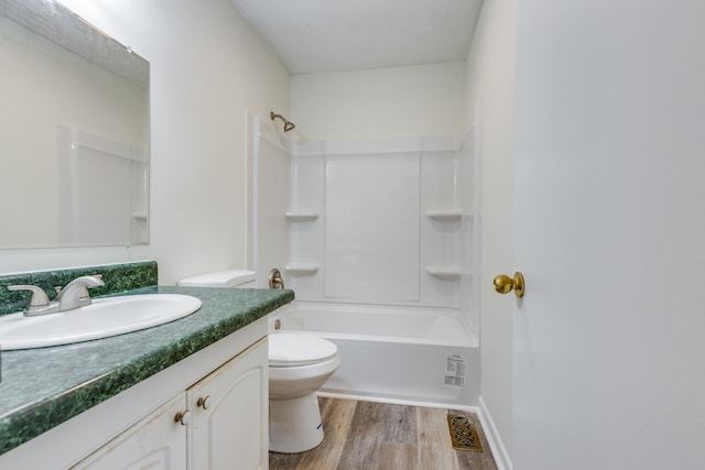 full bathroom with vanity, hardwood / wood-style flooring, toilet, and shower / bath combination