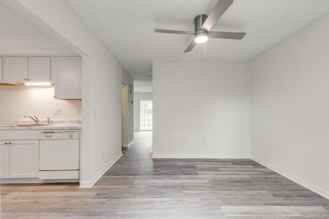 kitchen with white cabinetry, light hardwood / wood-style flooring, dishwasher, and sink