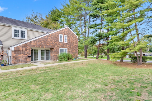 view of home's exterior with a lawn