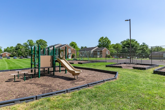 view of playground with a lawn