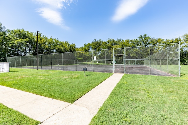 surrounding community with a lawn and tennis court