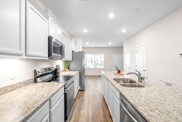 kitchen featuring sink, white cabinets, stainless steel appliances, and dark hardwood / wood-style floors