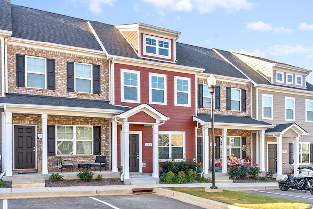 townhome / multi-family property with a porch