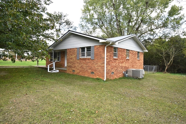 view of side of home featuring a yard and cooling unit