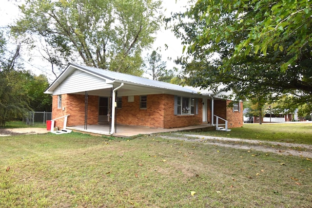 single story home featuring a patio and a front yard