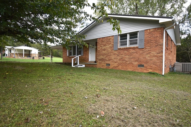 view of front of property with cooling unit and a front lawn