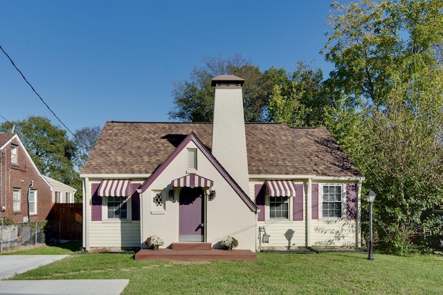 english style home with a front yard