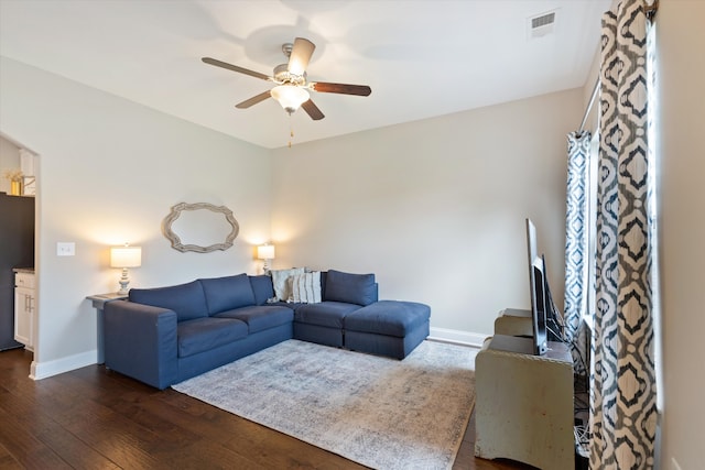 living room featuring dark hardwood / wood-style floors and ceiling fan