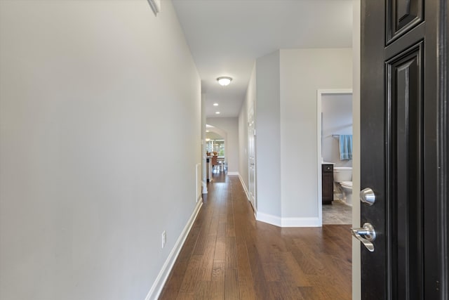 corridor featuring dark hardwood / wood-style flooring