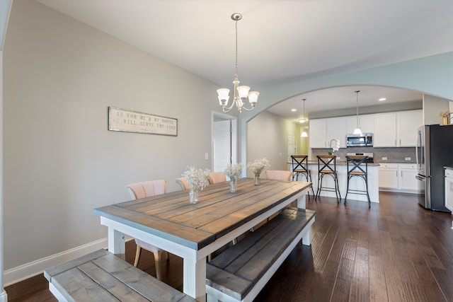 dining room with a notable chandelier and dark hardwood / wood-style flooring