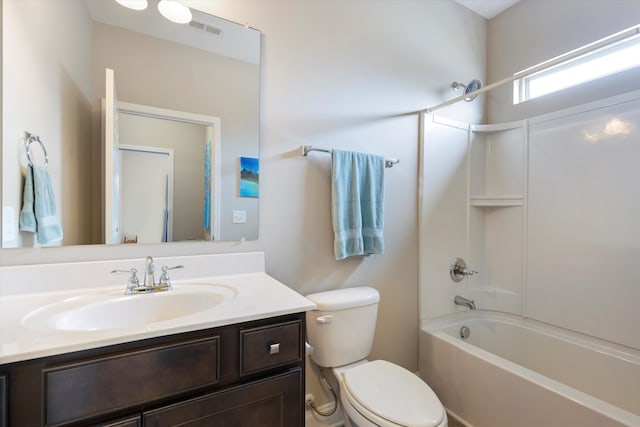 full bathroom featuring toilet, vanity, and washtub / shower combination