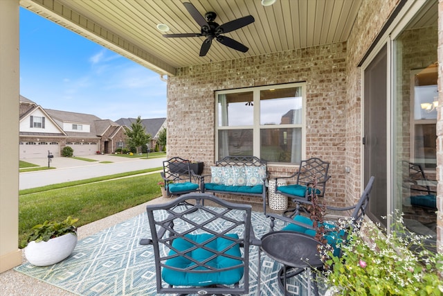 view of patio / terrace featuring a garage and ceiling fan