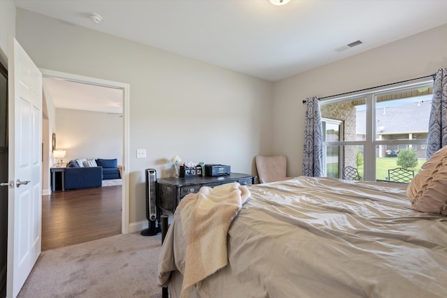 bedroom with dark hardwood / wood-style floors